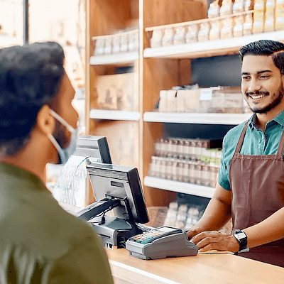 A customer completing a transaction at a staffed Anytime Capital counter