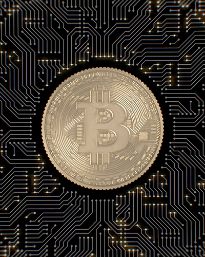 A Bitcoin coin on a circuit board